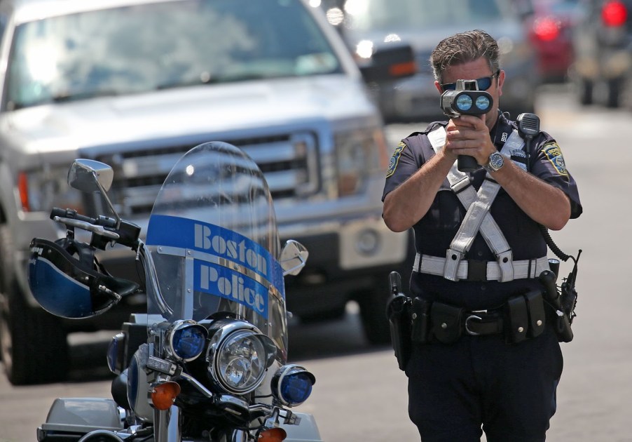 A police officer using a radar gun.