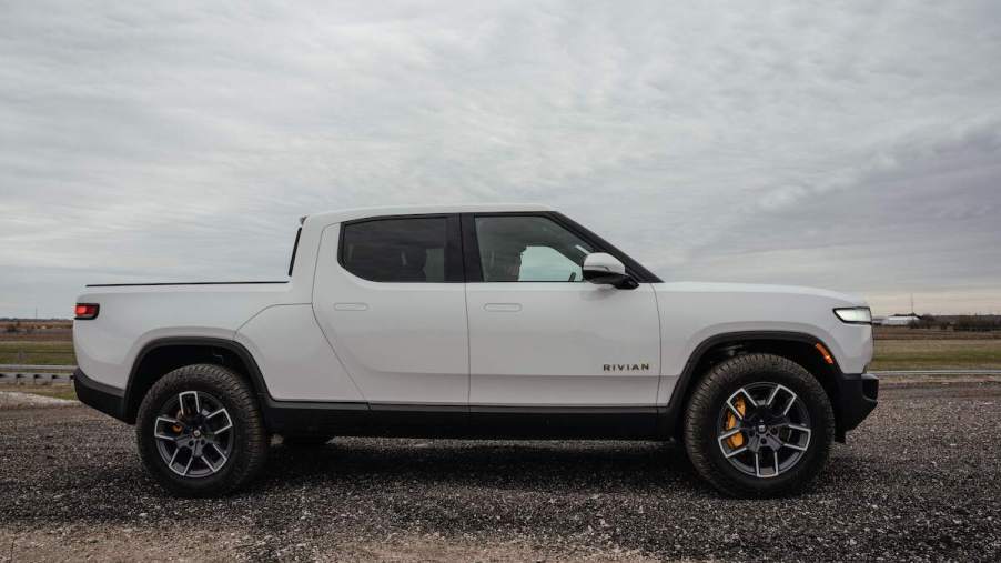 A white Rivian R1T parked outdoors.