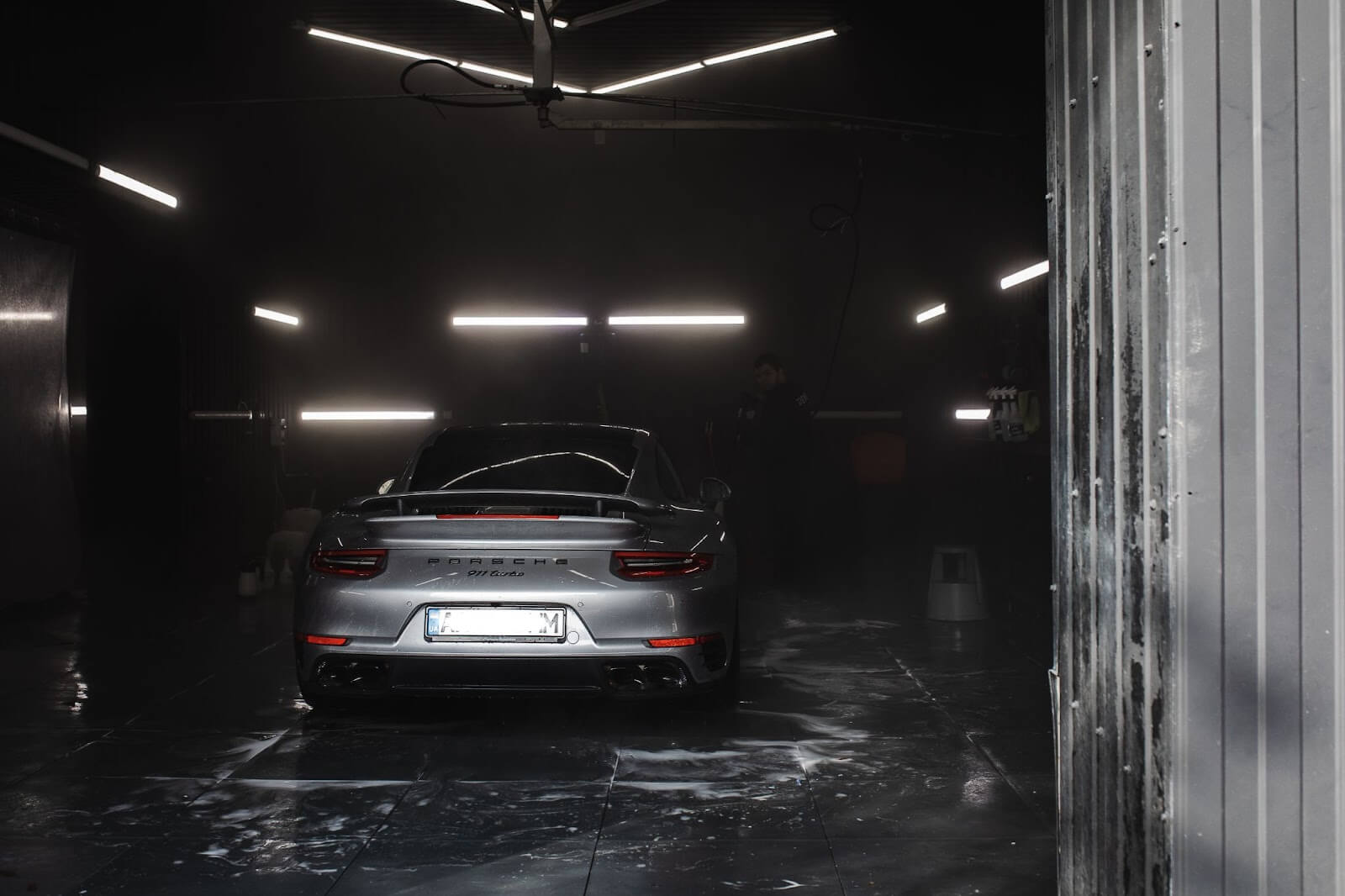 Porsche in a car wash bay