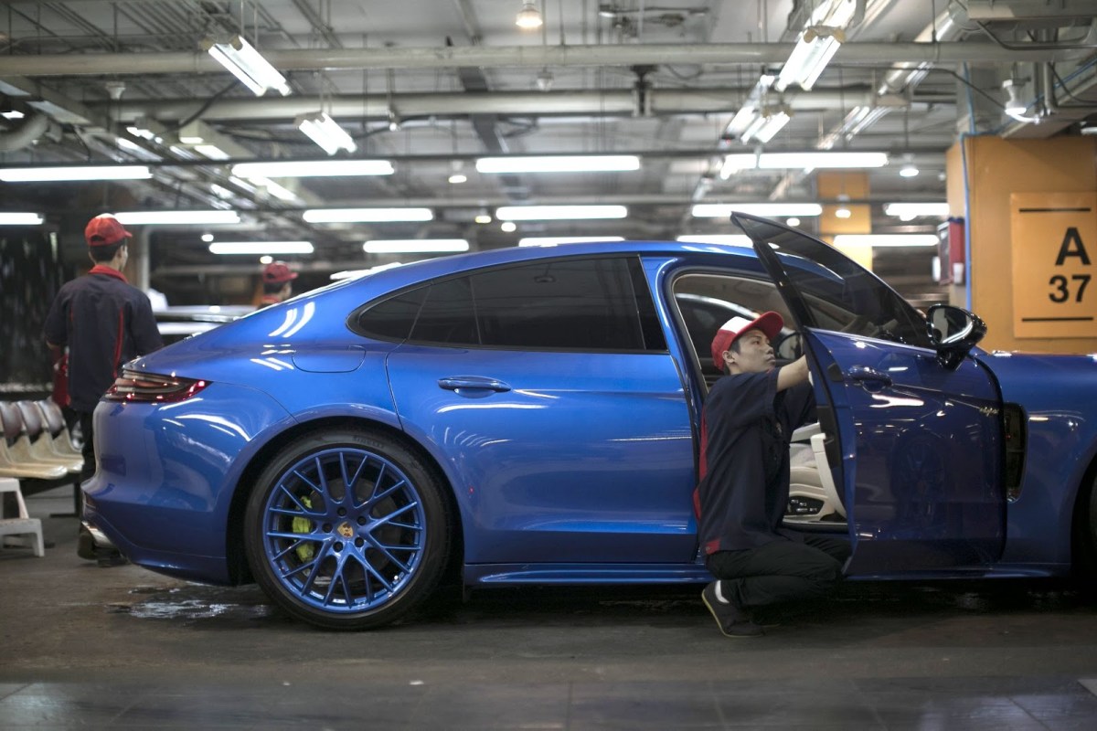 Hiring a detailer like the man shown here will help make your car look its best.