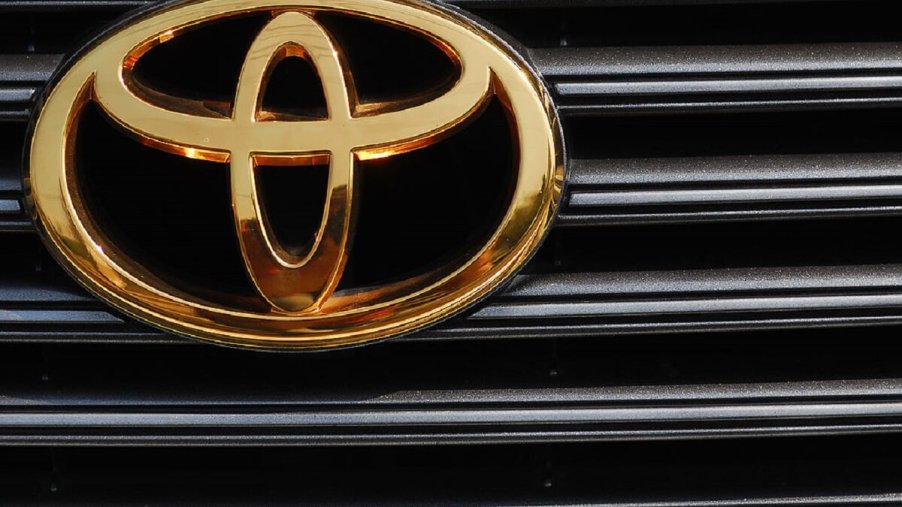 A used Toyota car shows off its problem-free gold badge on its grille.