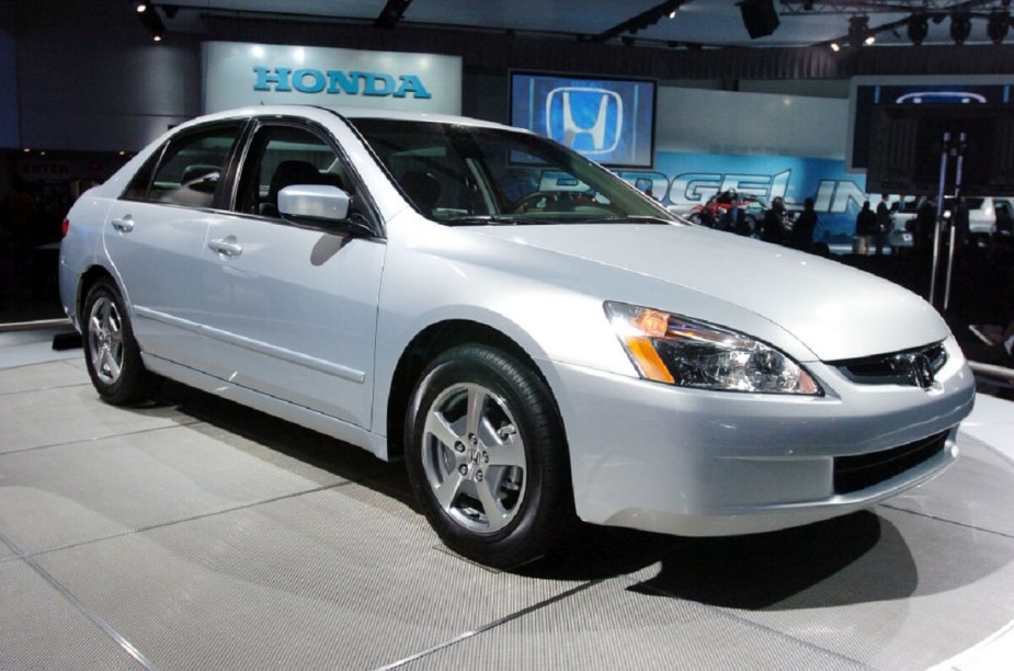 A 2003 Honda Accord, one of the least reliable vehicles per owners, shows off its silver paintwork at a show. 