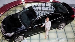 An overhead shot of a black Hyundai Equus luxury sedan with Hyundai's first female vice president: Choi Myoung Wha