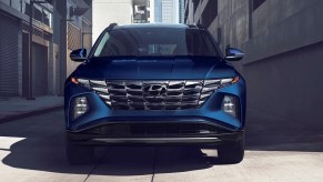 A blue 2023 Hyundai Tucson Hybrid small hybrid SUV is parked.