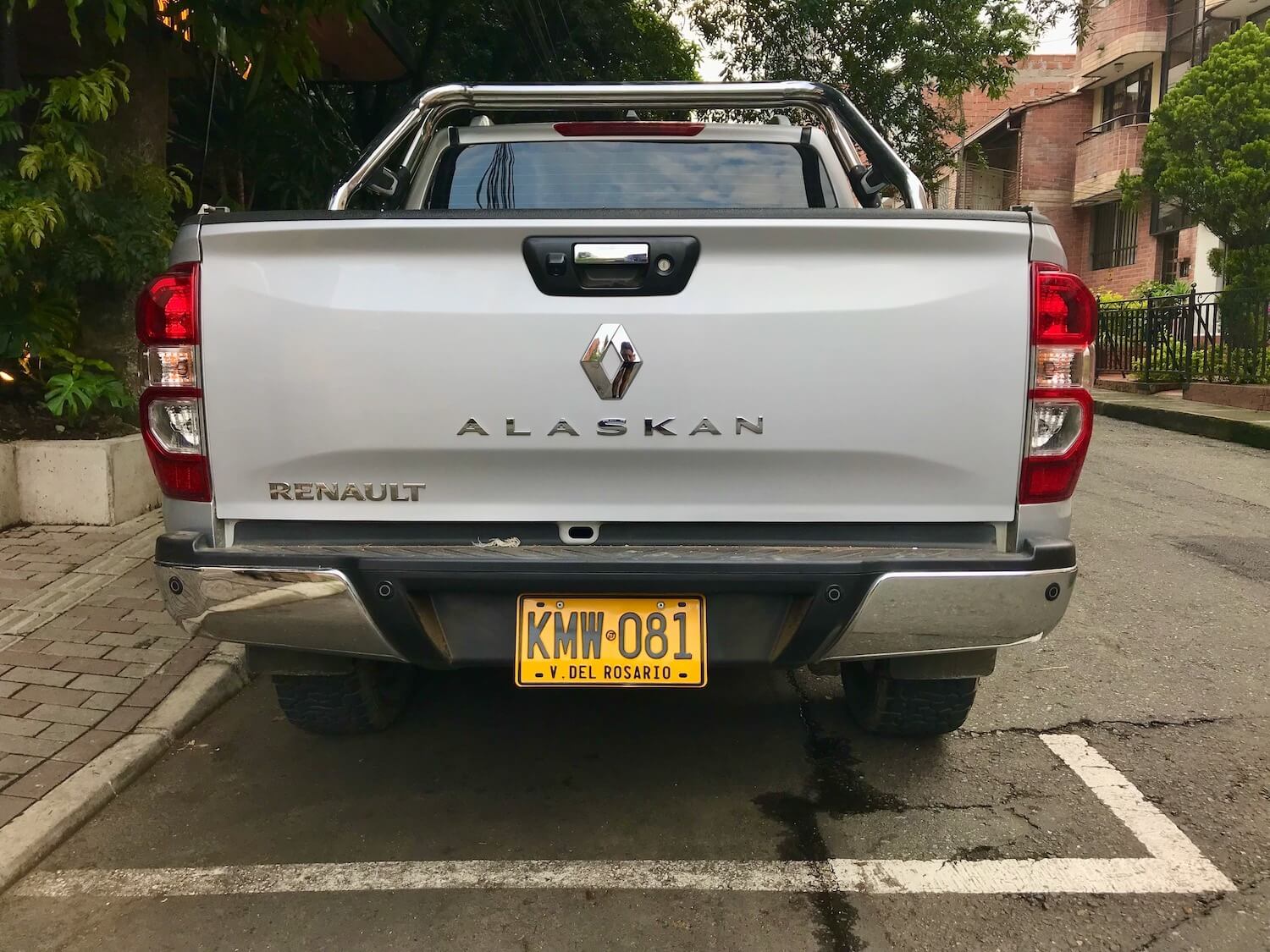 The tailgate of a Renault midsize pickup truck on the streets of Medellin Colombia, with its "Alaskan" badge visible.