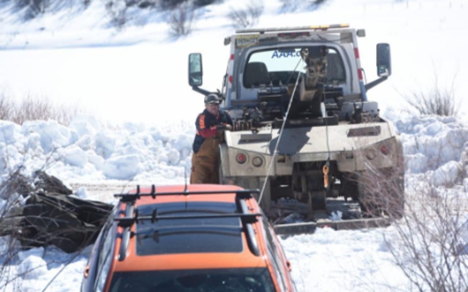 Jeep Cherokee Being Pulled Out of the Yampa River by a Tow Truck