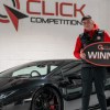 Lamborghini Hurracan Winner pictured standing next to his black supercar.