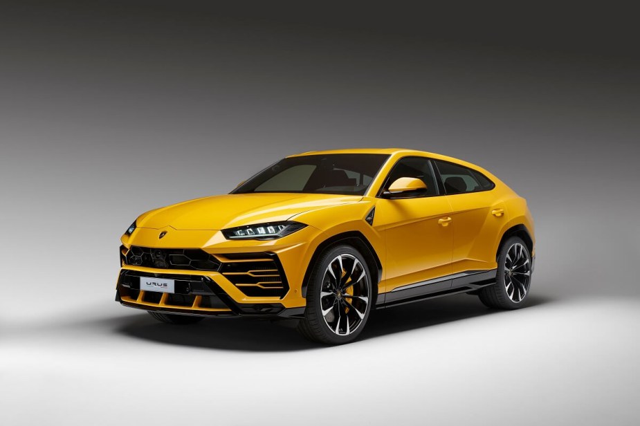 A yellow Lamborghini Urus SUV shows off its dramatic front-end styling.