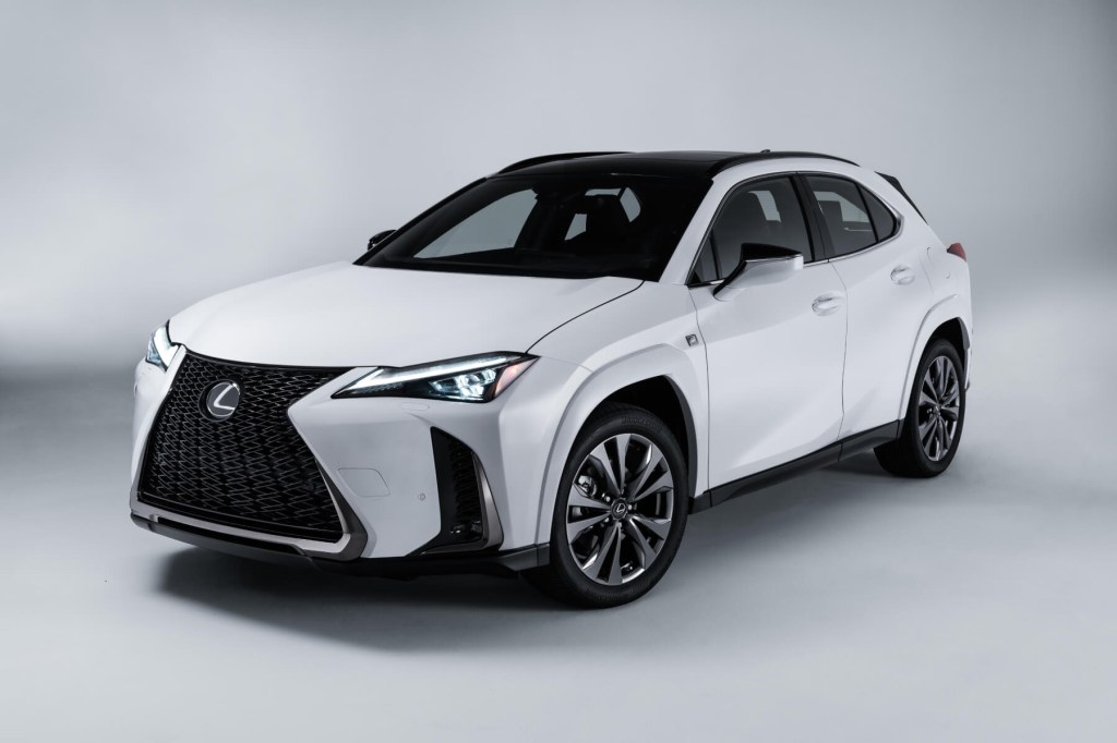A white Lexus UX hybrid crossover in front of a white background.