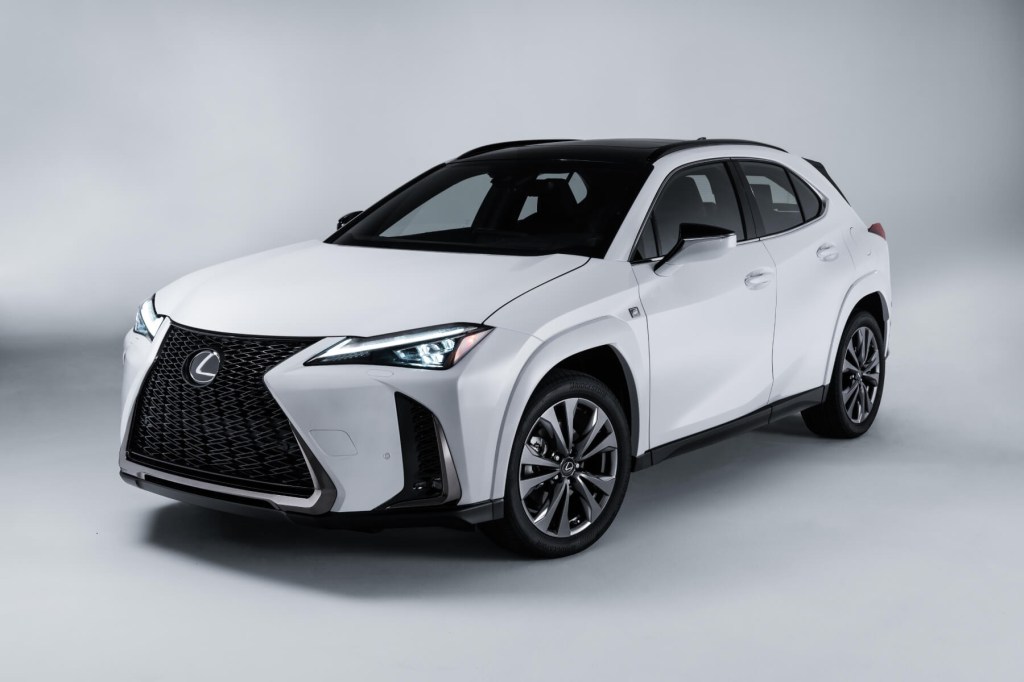 A white Lexus UX hybrid crossover in front of a white background. 