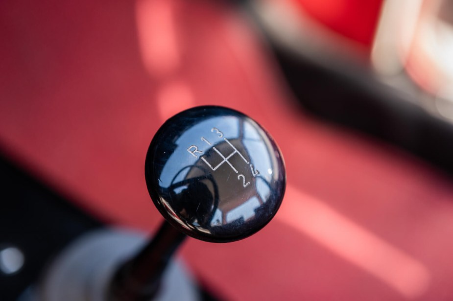 Closeup of the stick shift lever in an older manual transmission pickup truck.