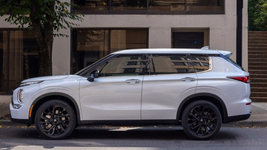 A white 2023 Mitsubishi Outlander small SUV is parked.