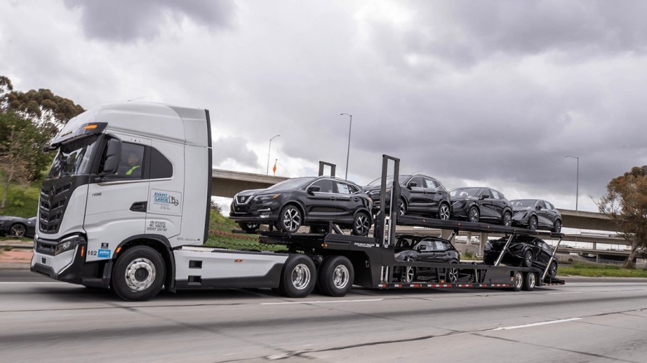 Nikola Electric Semi-Truck Towing a Load of Nissan Ariya SUVs from the Port of Los Angeles to a Local Dealership