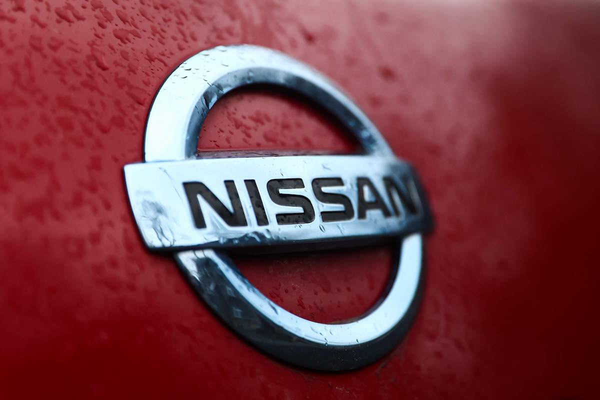 A Nissan logo on a red car.