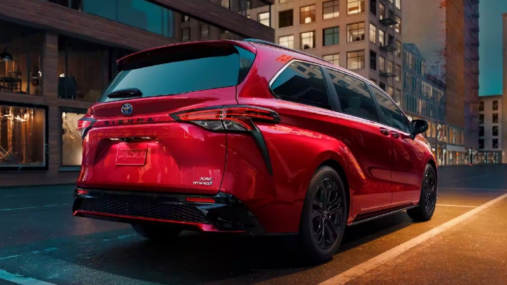 Rear angle view of red 2023 Toyota Sienna minivan