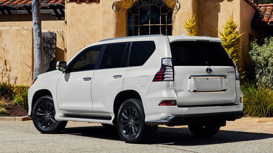 Rear perspective of a 2023 Lexus GX in white, noon sun. 