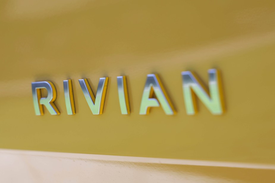Close-up shot of the Rivian badge on a new R1S electric SUV.