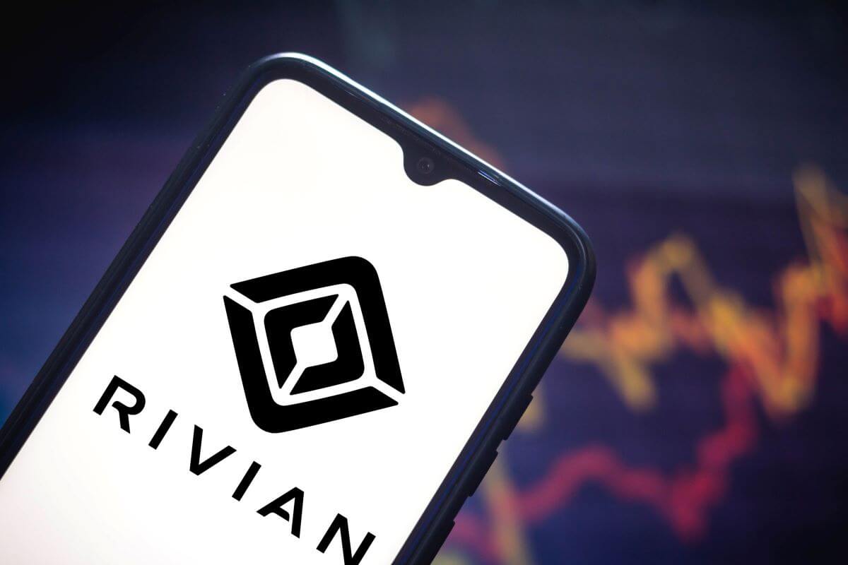 The Rivian logo on a smartphone symbolizing a software update by the automaker company