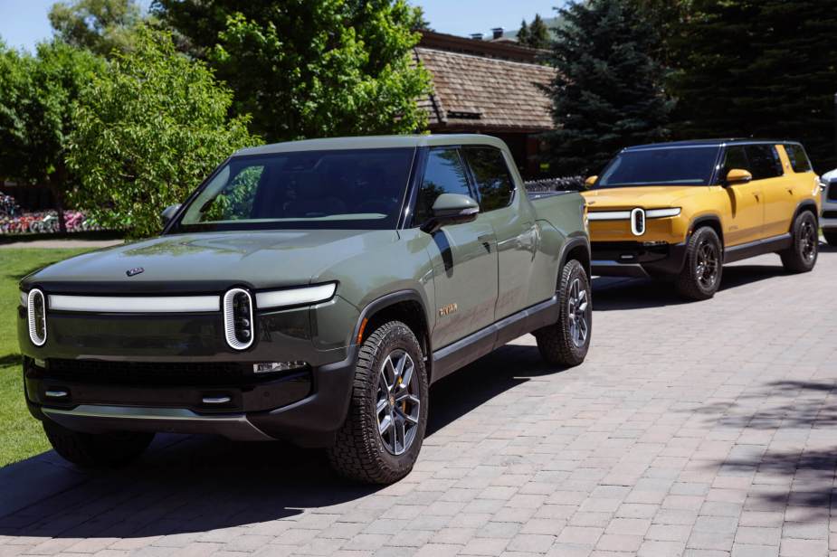 A Rivian R1T electric truck sits on a driveway in the sun. This model was affected by a charging station failure. 