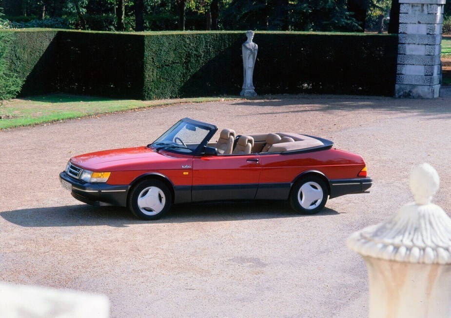 A used red Saab 900 Convertible shows off its drop-top. 