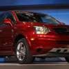 A red Saturn Vue parked indoors.