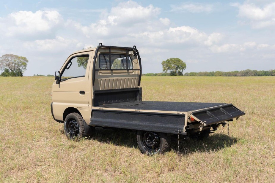 Promo photo of the bed of a Suzuki Carry "Kei-Class" mini truck with its sideboards folded down.