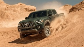 A 2023 Toyota Tacoma drives through sand. The 2024 Tacoma will be here soon.