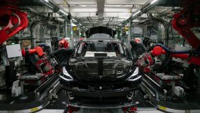 A black Tesla SUV being assembled in a plant like the factory the EV automaker is planning to build in Mexico.