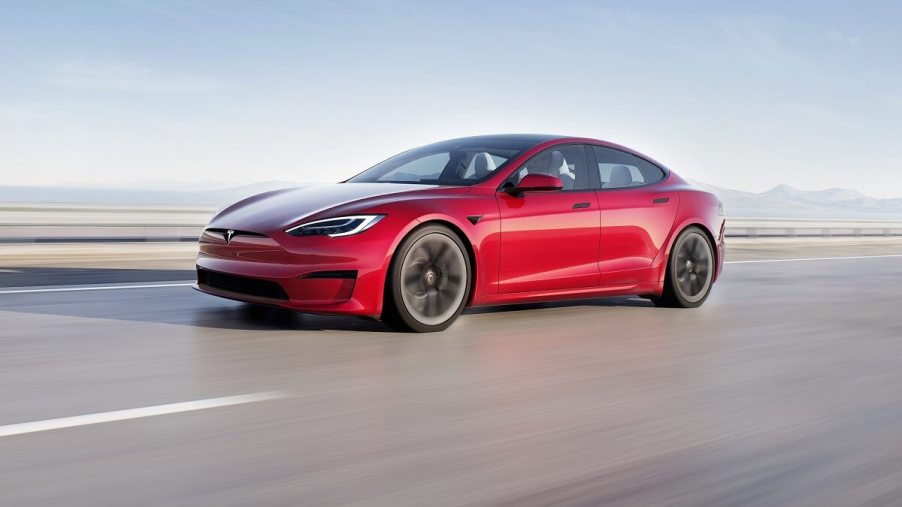 A 2023 Tesla Model S safely blasts down a desert road.