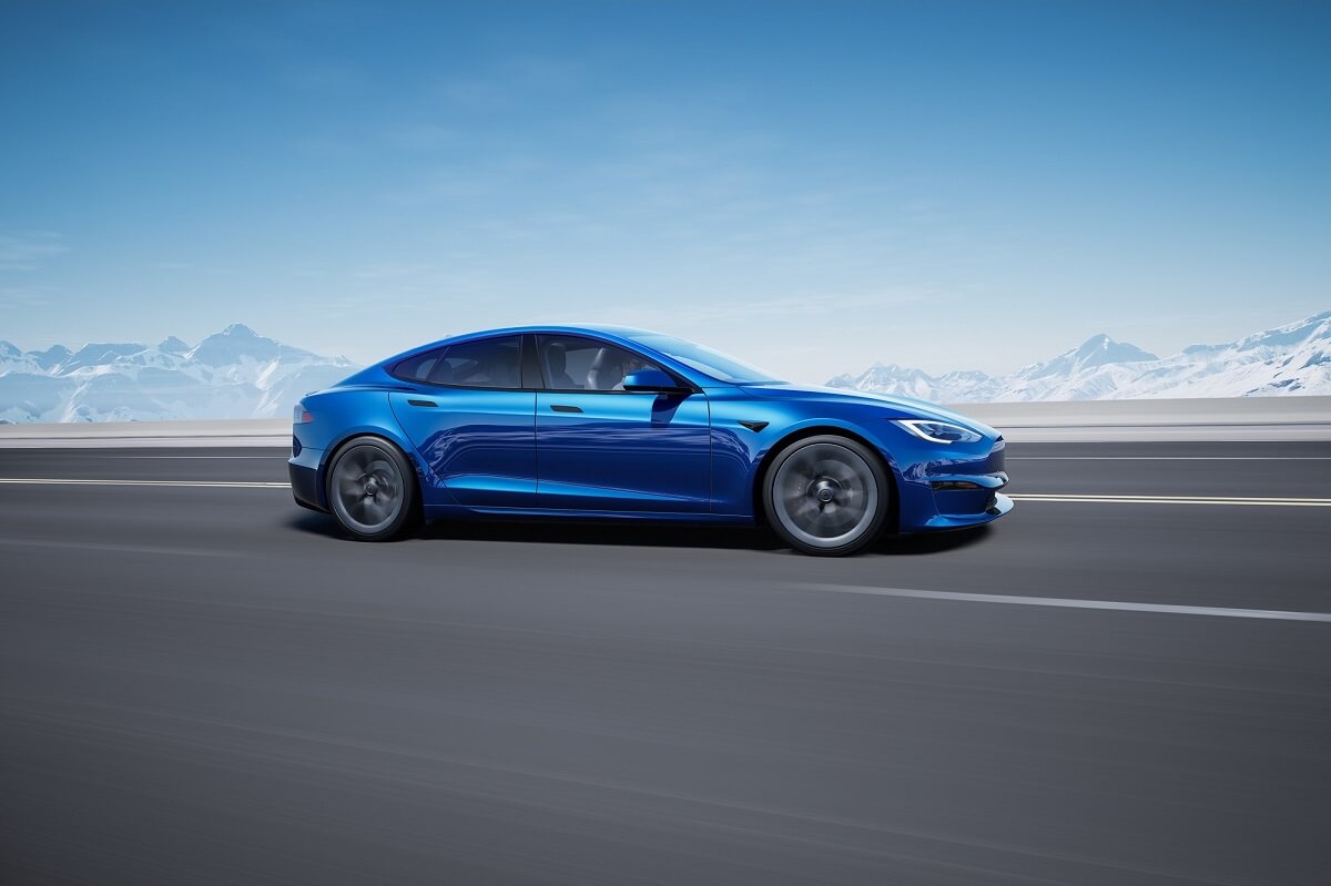 A bright blue Tesla Model S Plaid displays its profile on a test track.