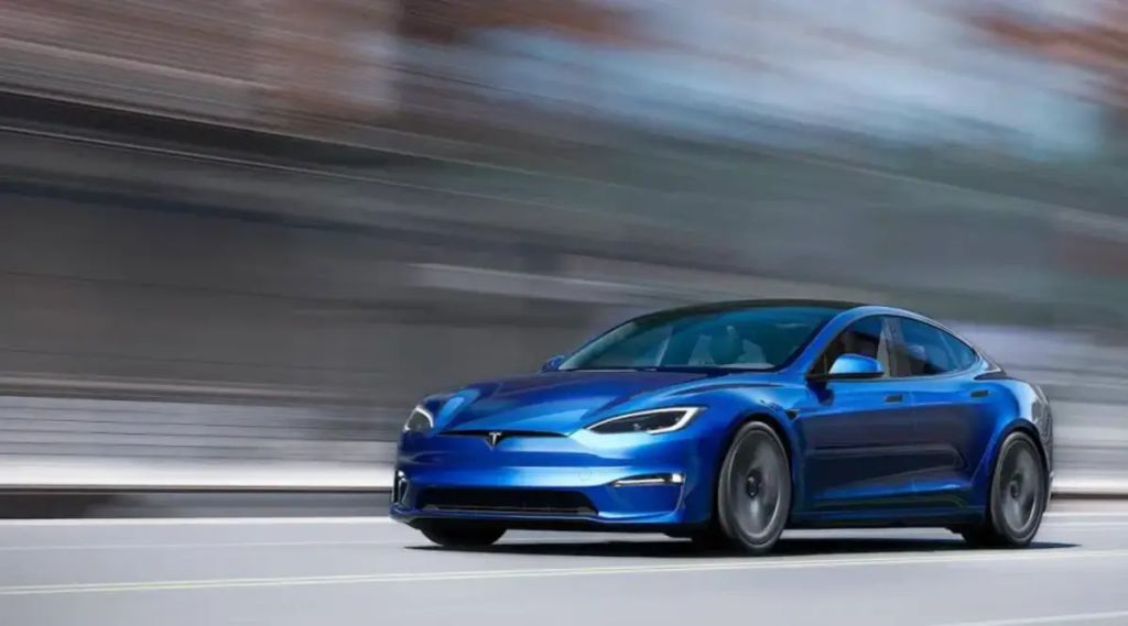 Blue Tesla Model 3 in motion