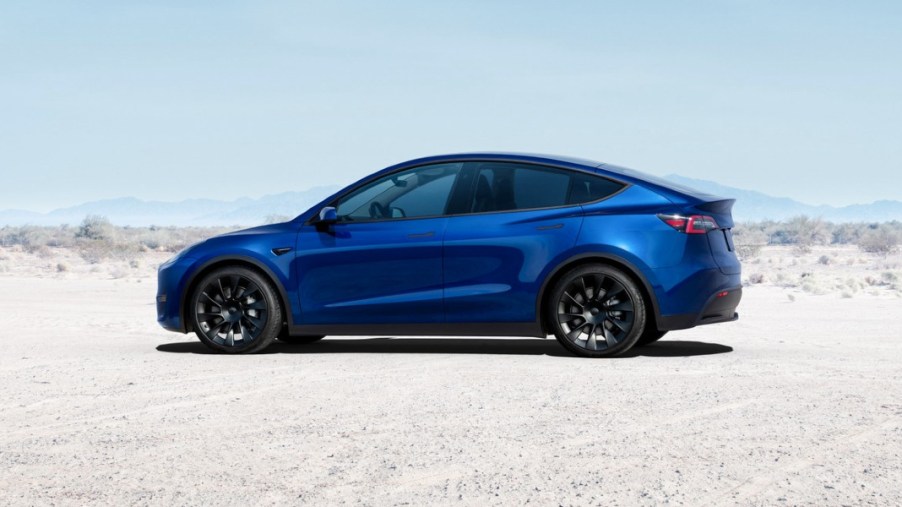 A blue 2023 Tesla Model Y is parked.