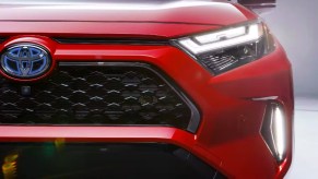 The front right side of a red 2023 Toyota RAV4 Prime, the predecessor to the new 2024 RAV4.
