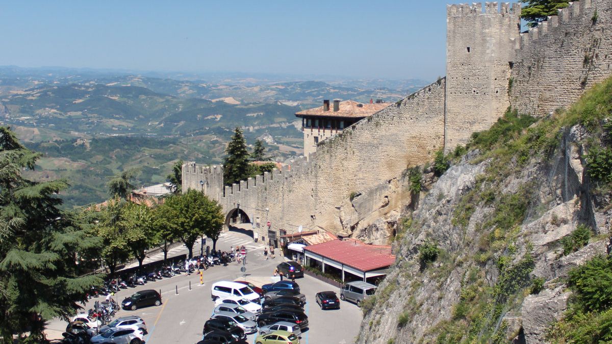 Vehicles parked by Guaita Tower in San Marino, the only country in the world with more cars than people