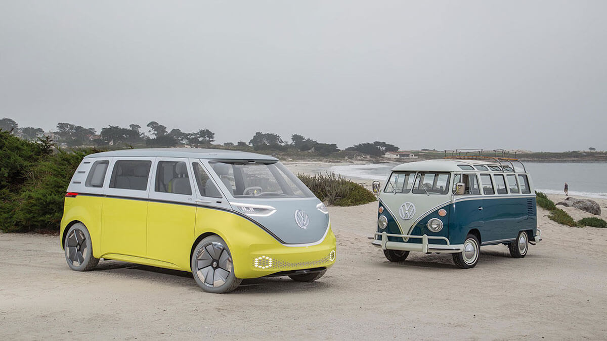 Electric Volkswagen ID. Buzz bus in two different colors – neon yellow and blue.