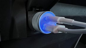A pair of car chargers plugged in