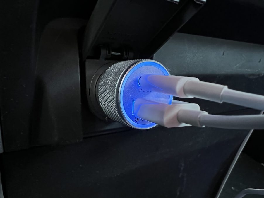 A pair of car chargers plugged in