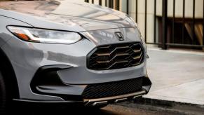 The front end of headlights, hood, and grille, of a 2023 Honda HR-V compact SUV model