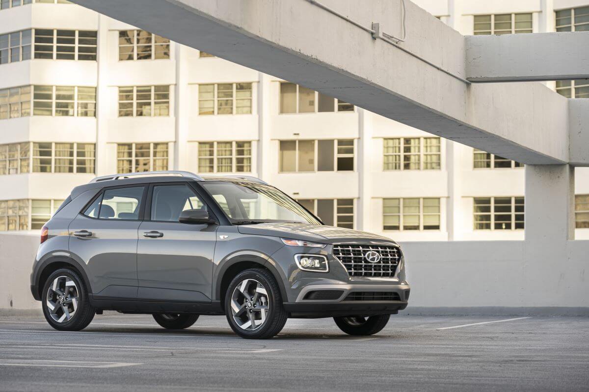 A gray 2023 Hyundai Venue subcompact SUV model on the top of a parking structure