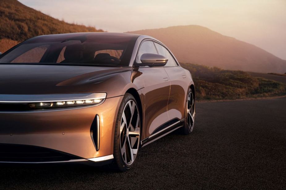 A Lucid Air luxury electric car driving down a road.