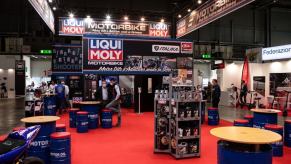 A Motorcycle motor oil and fuel additives display, including octane boosters, at EICMA in Milan, Italy