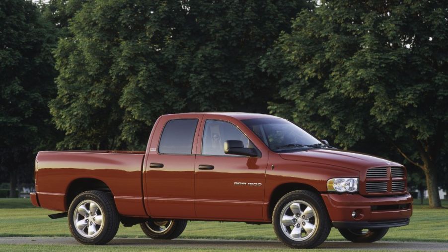 A red 2003 Dodge Ram 1500 pickup truck model in a park near trees
