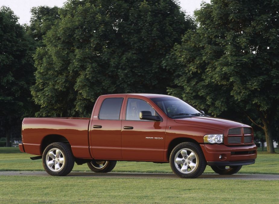 A red 2003 Dodge Ram 1500 pickup truck model in a park near trees
