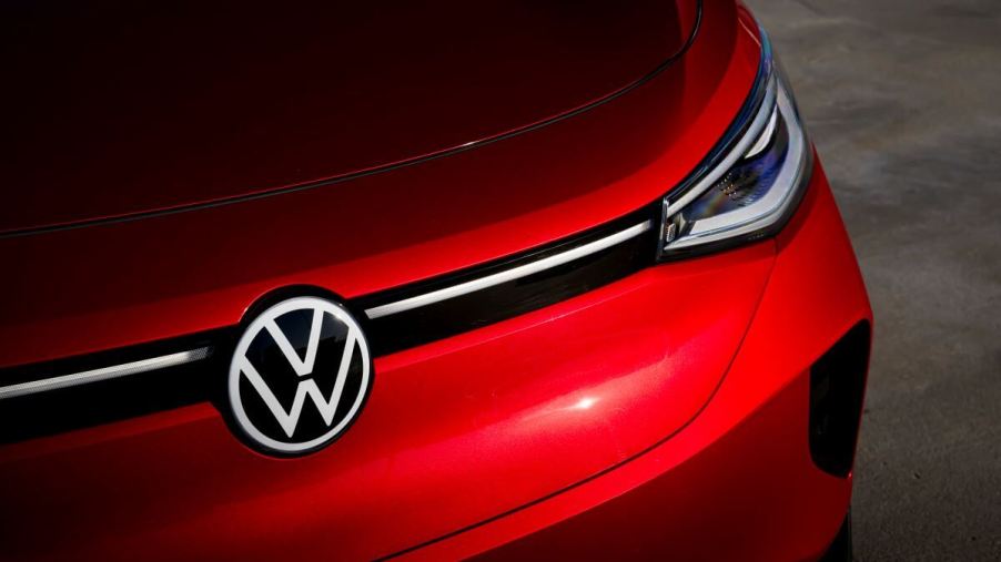 A shot of the hood, headlights, and logo/emblem of a red 2023 Volkswagen ID.4 electric compact SUV model