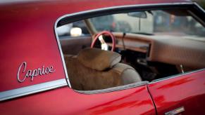 A red Chevy Caprice model with passenger window badging seen in Pacific Beach,