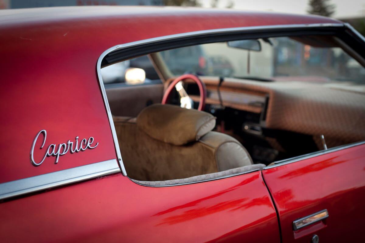 A red Chevy Caprice model with passenger window badging seen in Pacific Beach,