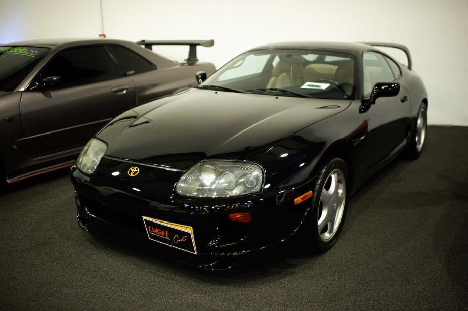 A fourth-generation Toyota Supra parked in a garage.