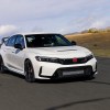 A white 2023 Honda Civic Type R hot hatch car corners on a track.