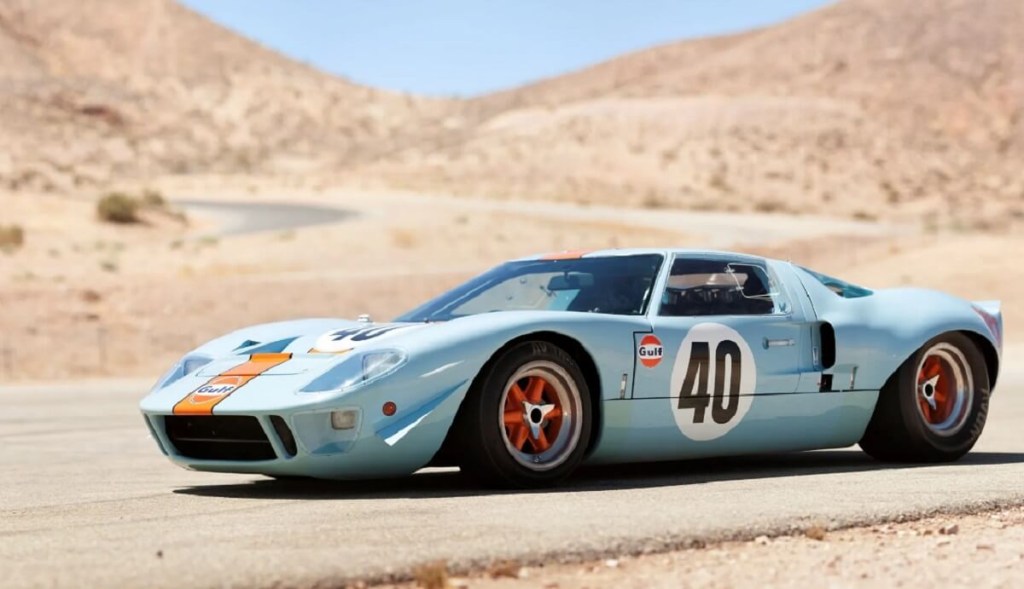 A 1968 Ford GT40 Gulf/Mirage Lightweight Racing Car parks in the desert.