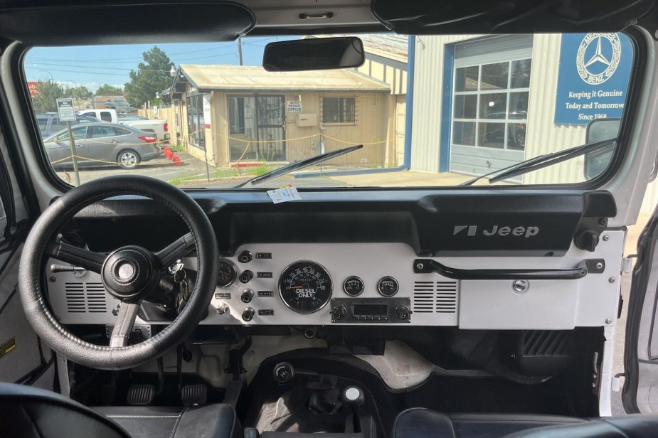 The dashboard of a Jeep CJ-8 Scrambler restomod, the diesel only sticker on its speedometer visible.